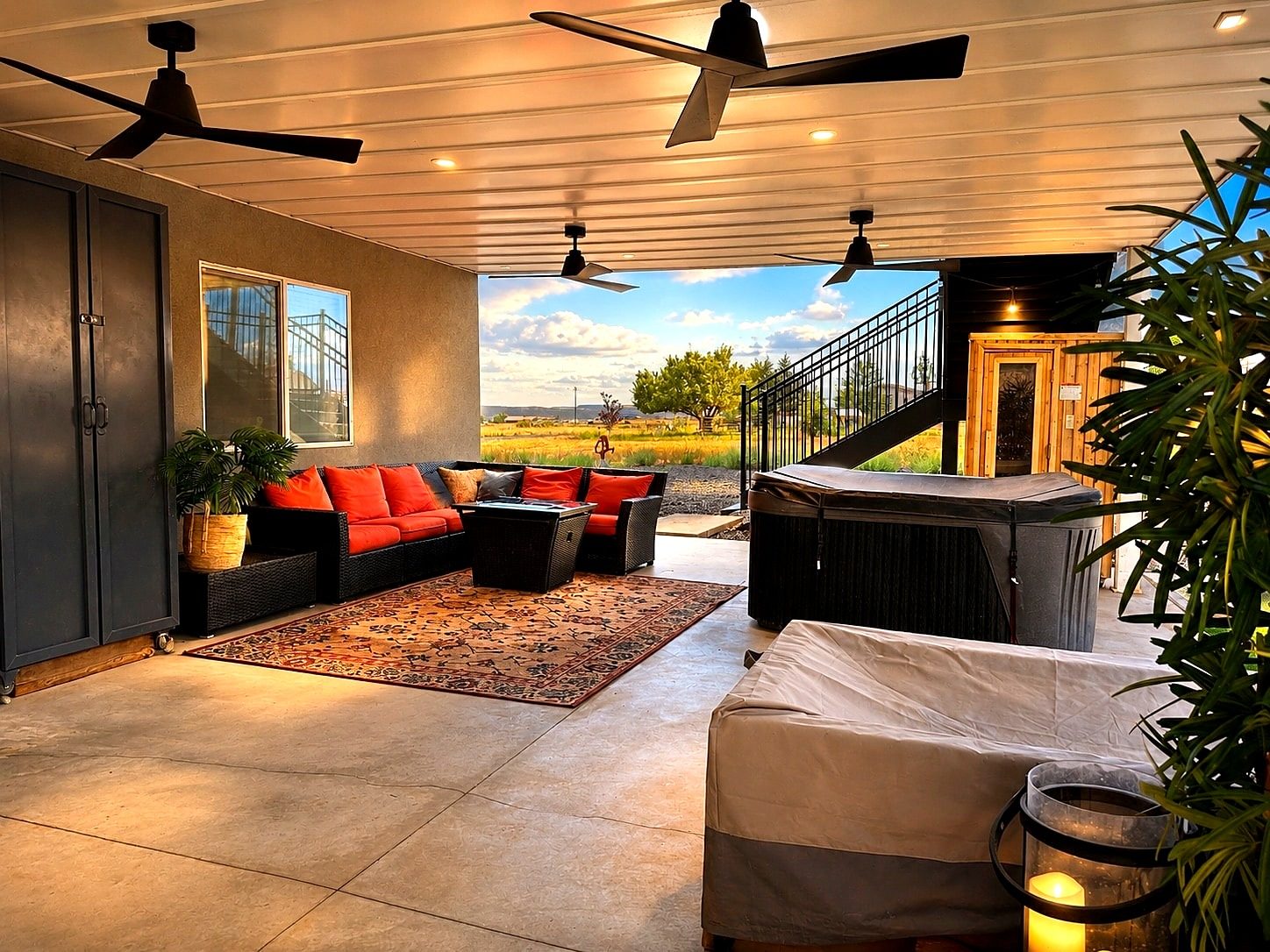Patio with cedar sauna, hot tub, and red cushions